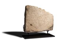 An Egyptian Limestone Relief Fragment with Serving Woman