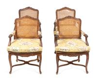 A Set of Four Louis XV Style Caned Oak Fauteuils