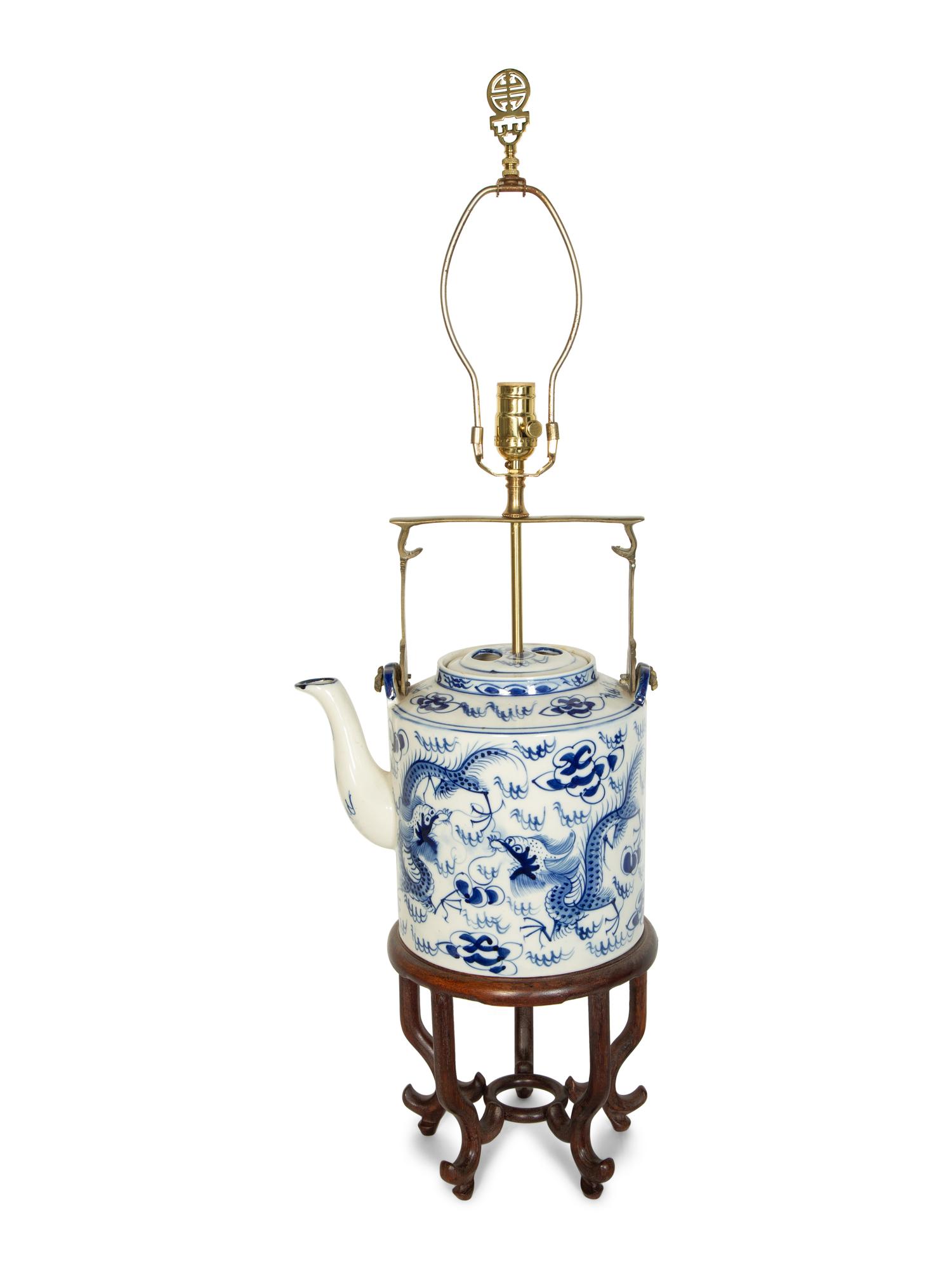 An Oversized Chinese Export Porcelain Teapot Mounted as a Lamp with a Wood Stand