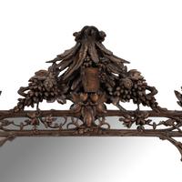 A Swiss "Black Forest" Carved Oak Mirror