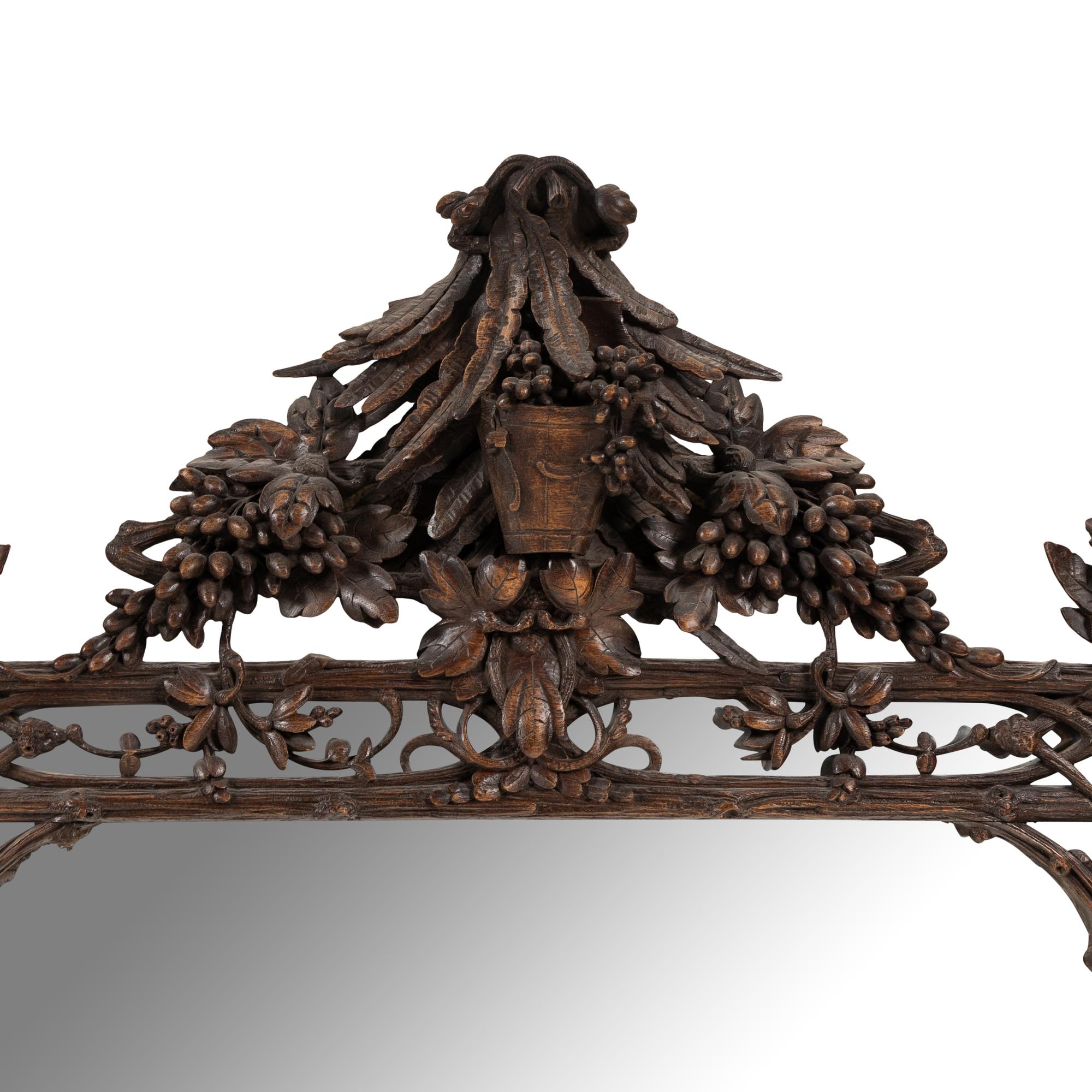 A Swiss "Black Forest" Carved Oak Mirror