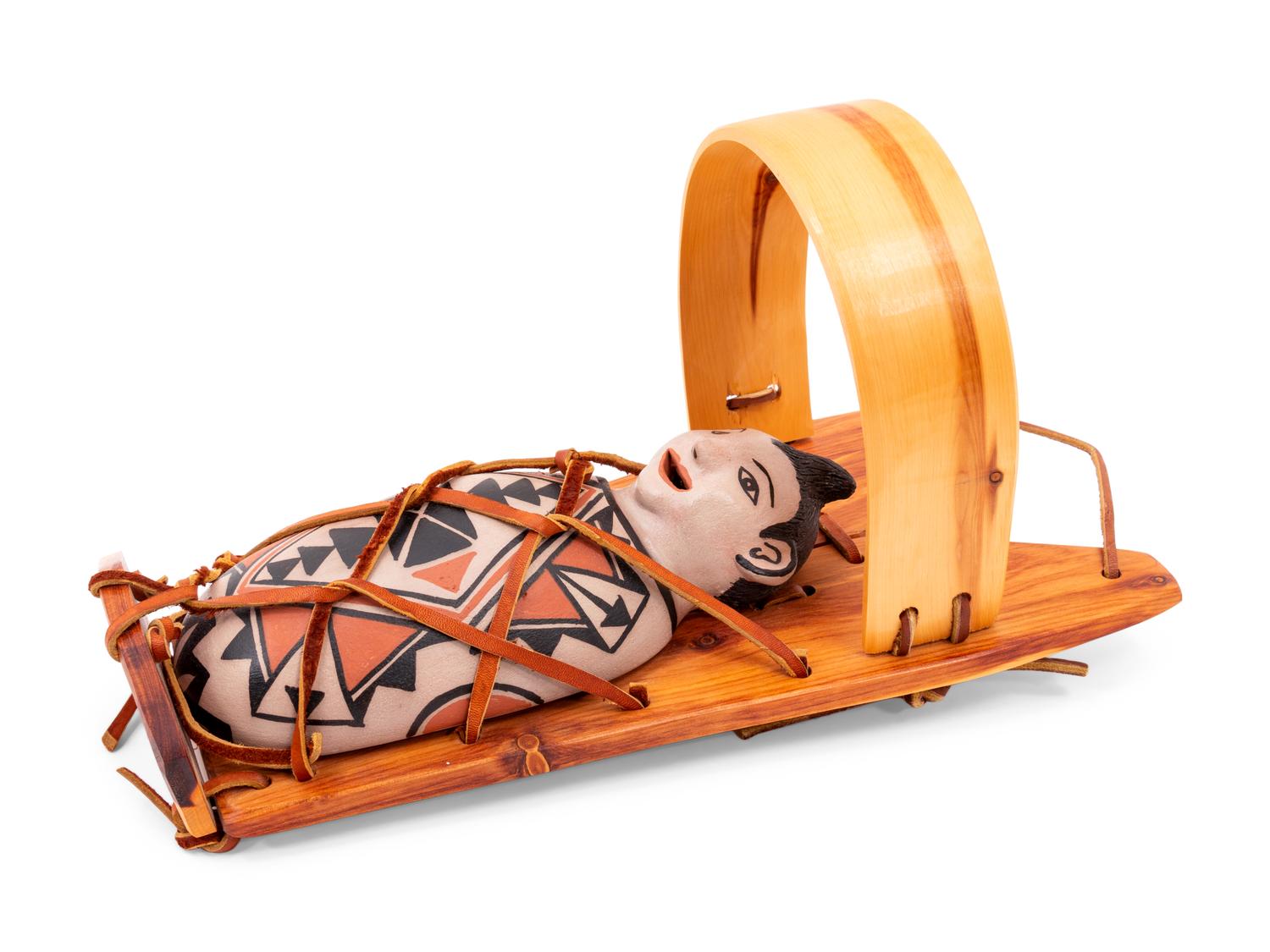 Pottery Doll in Cradle