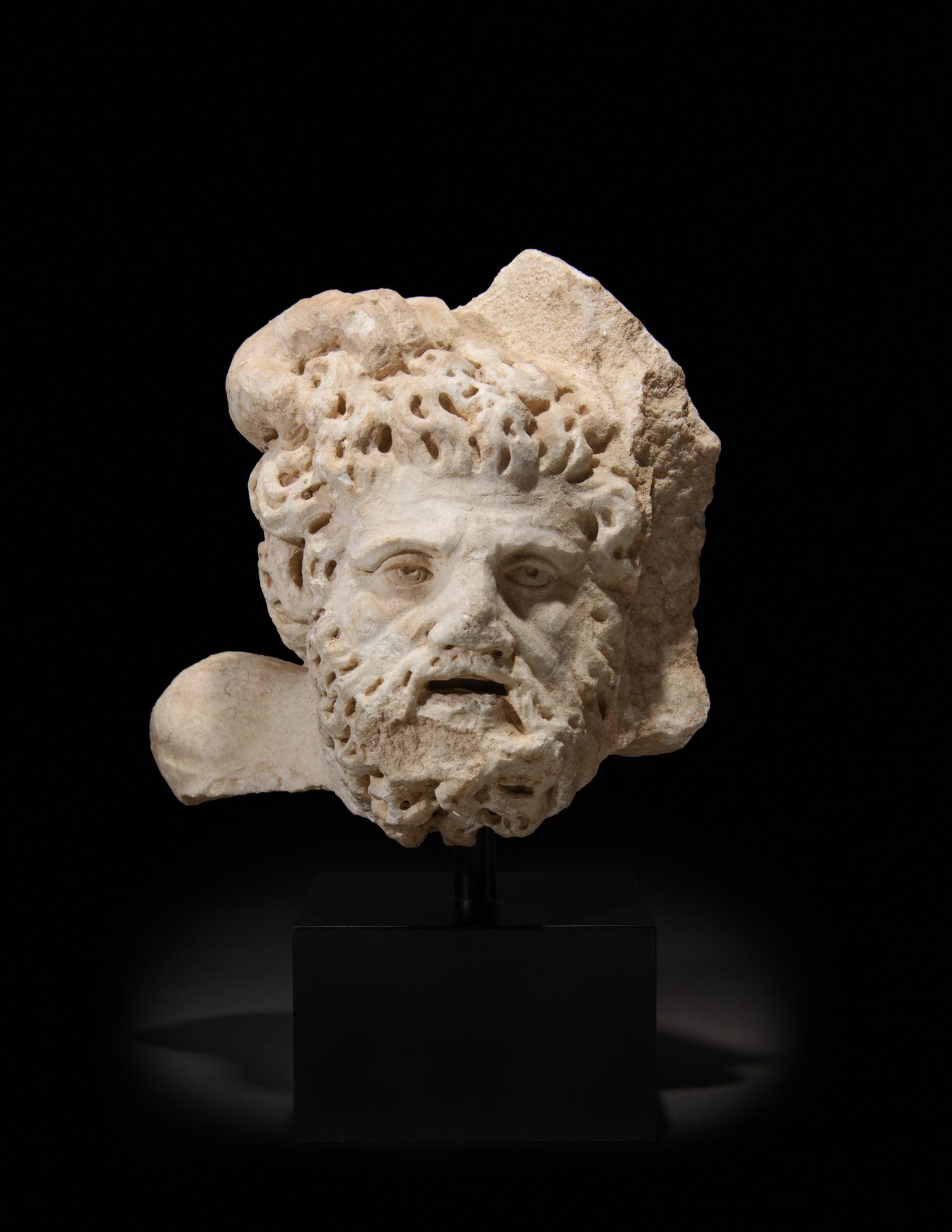 A Roman Marble Bearded Head, Perhaps a Giant, from a Relief