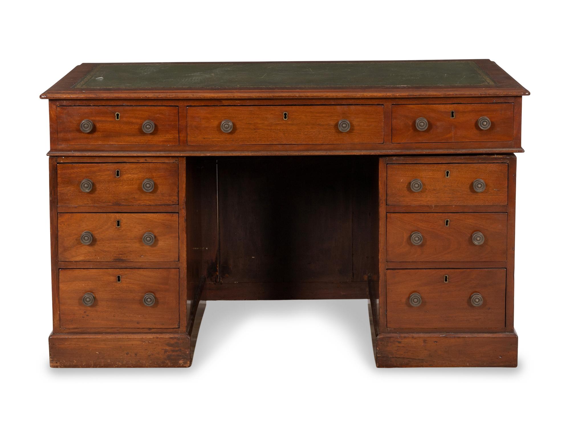 A George IV Walnut Kneehole Desk with Green Leather Inset Top