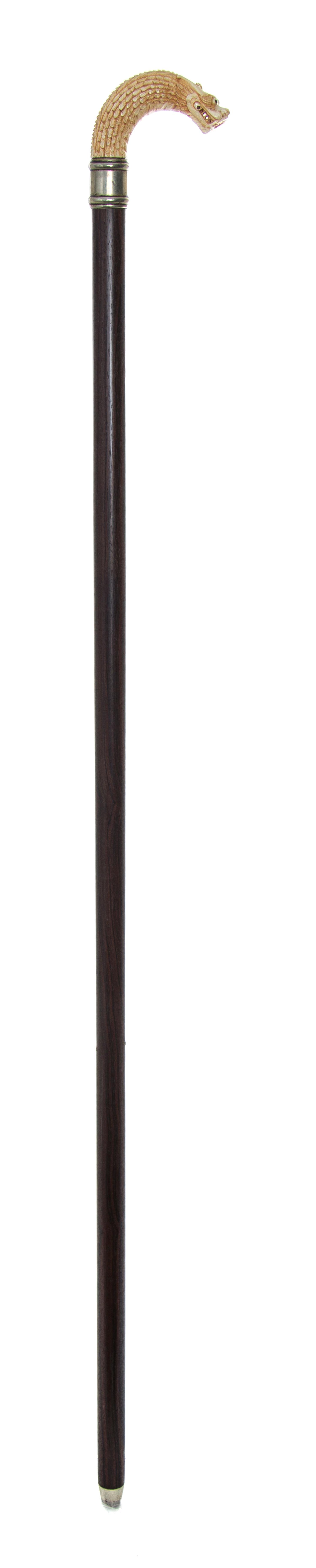 A Chinese Ivory Handled Cane, Length of handle 4 1/2 x length overall 35 inches.