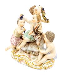 A Meissen Porcelain Group of Children Feeding a Goat