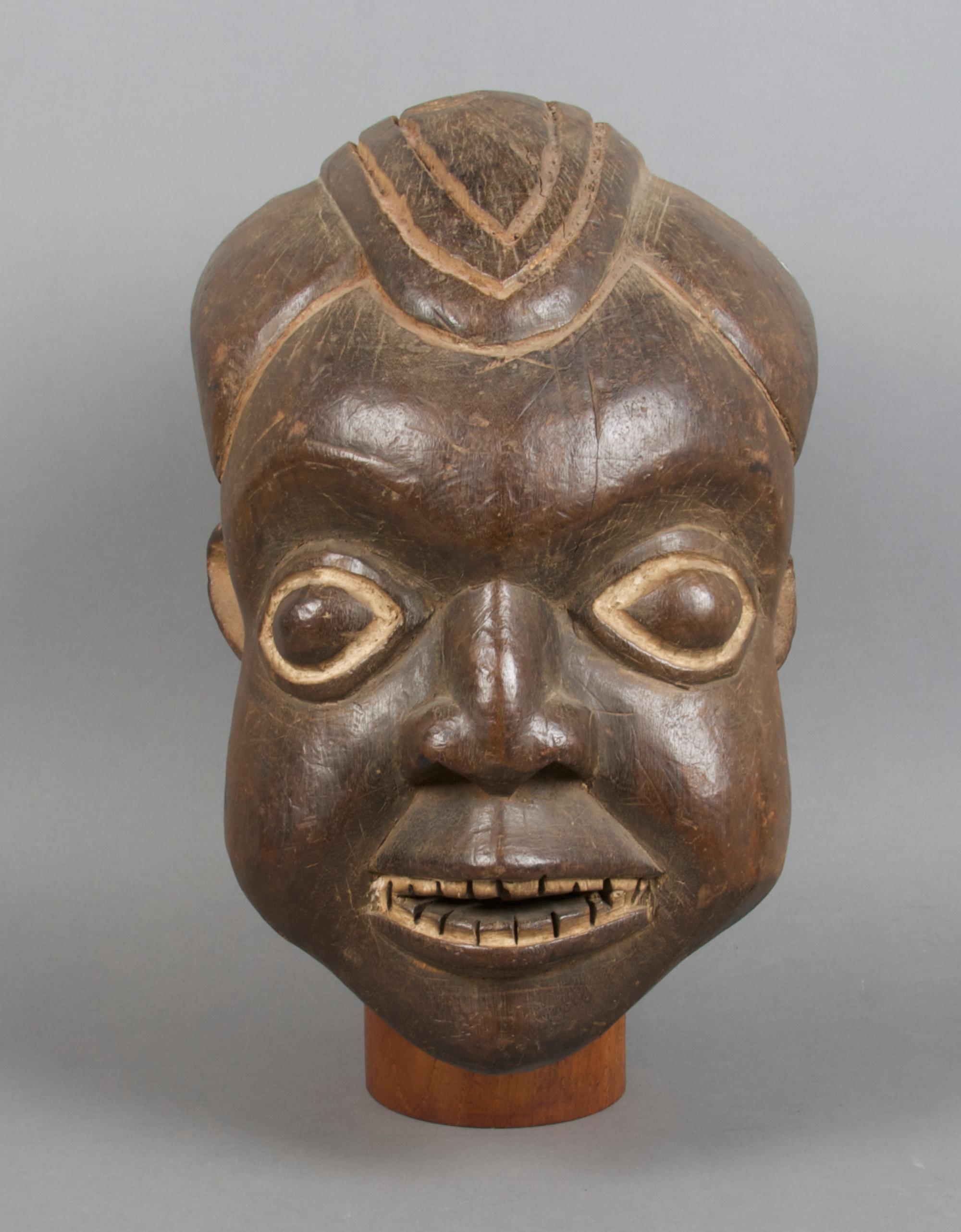 A Carved Helmet Mask, Bamum Height 13 inches.