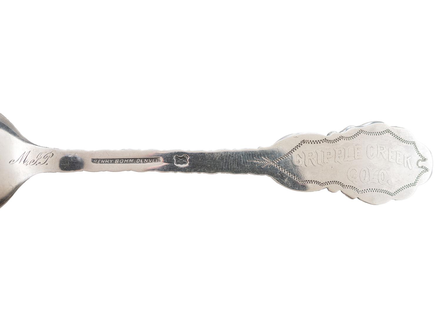 [WESTERN AMERICANA]. A group of 2 Henry Bohm silver banquet spoons commissioned by railroad magnate Otto Mears and featuring detailed mining scenes, ca 1890s.
