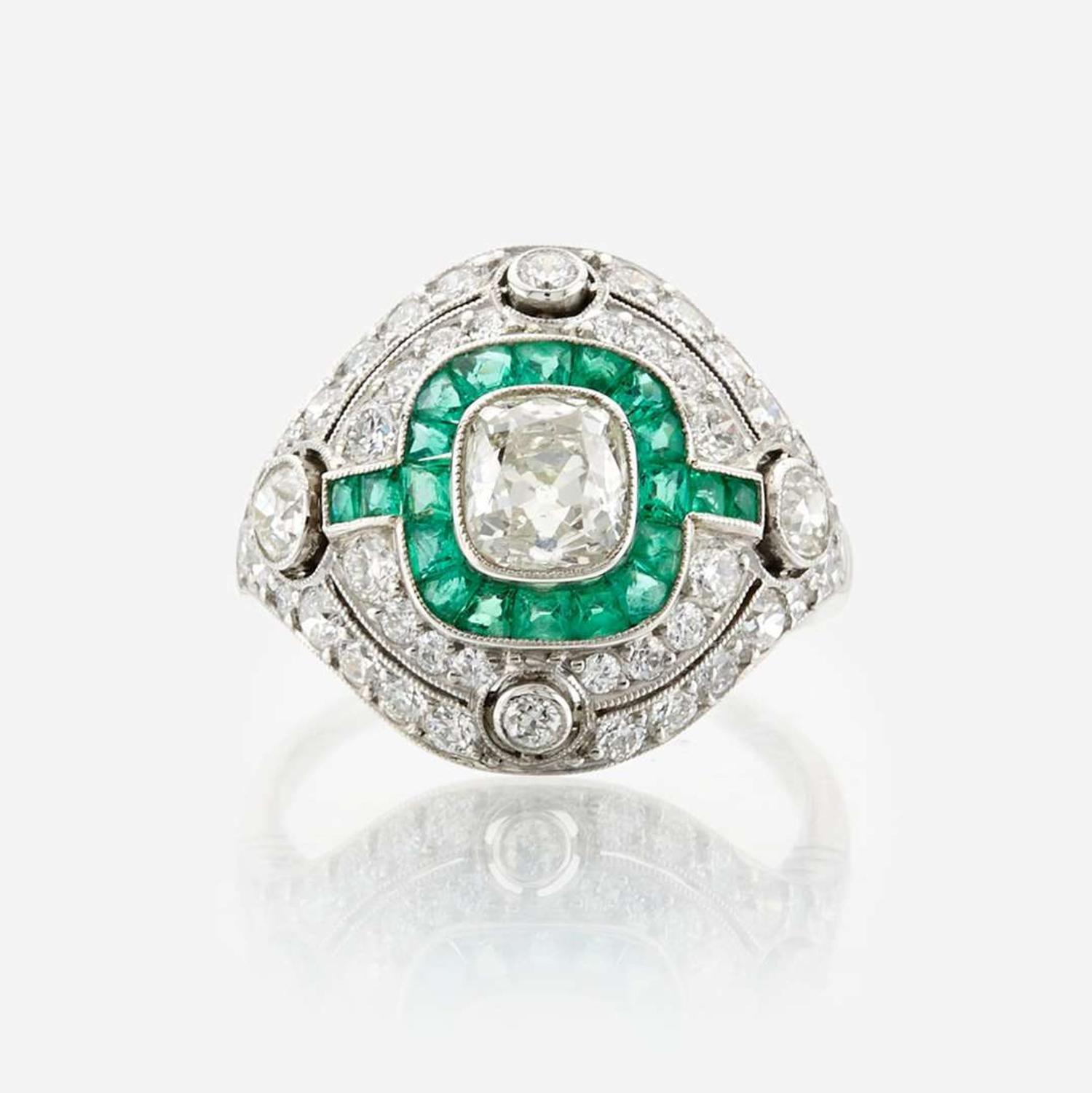 A diamond, emerald, and platinum ring