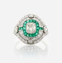 A diamond, emerald, and platinum ring