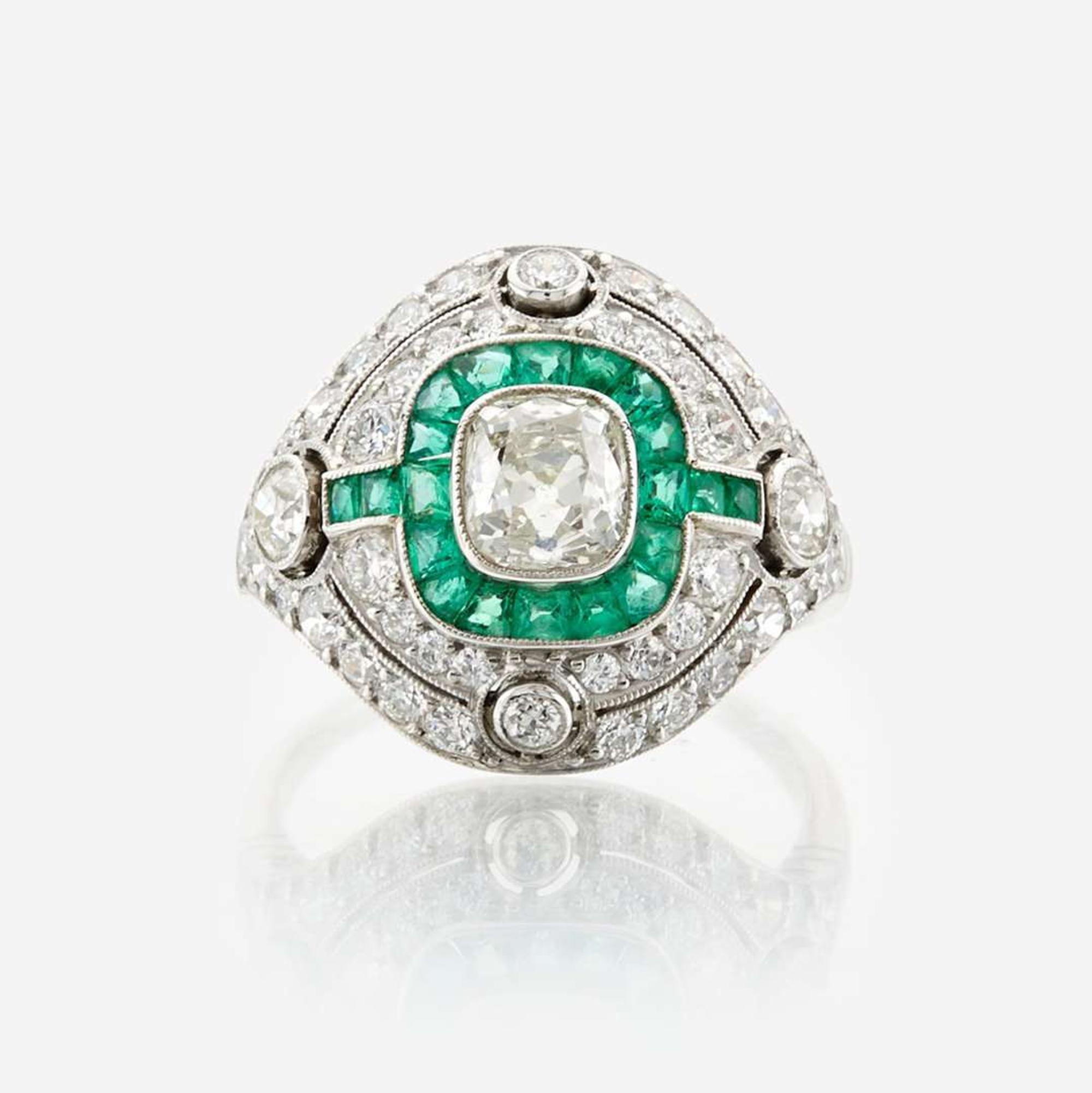 A diamond, emerald, and platinum ring