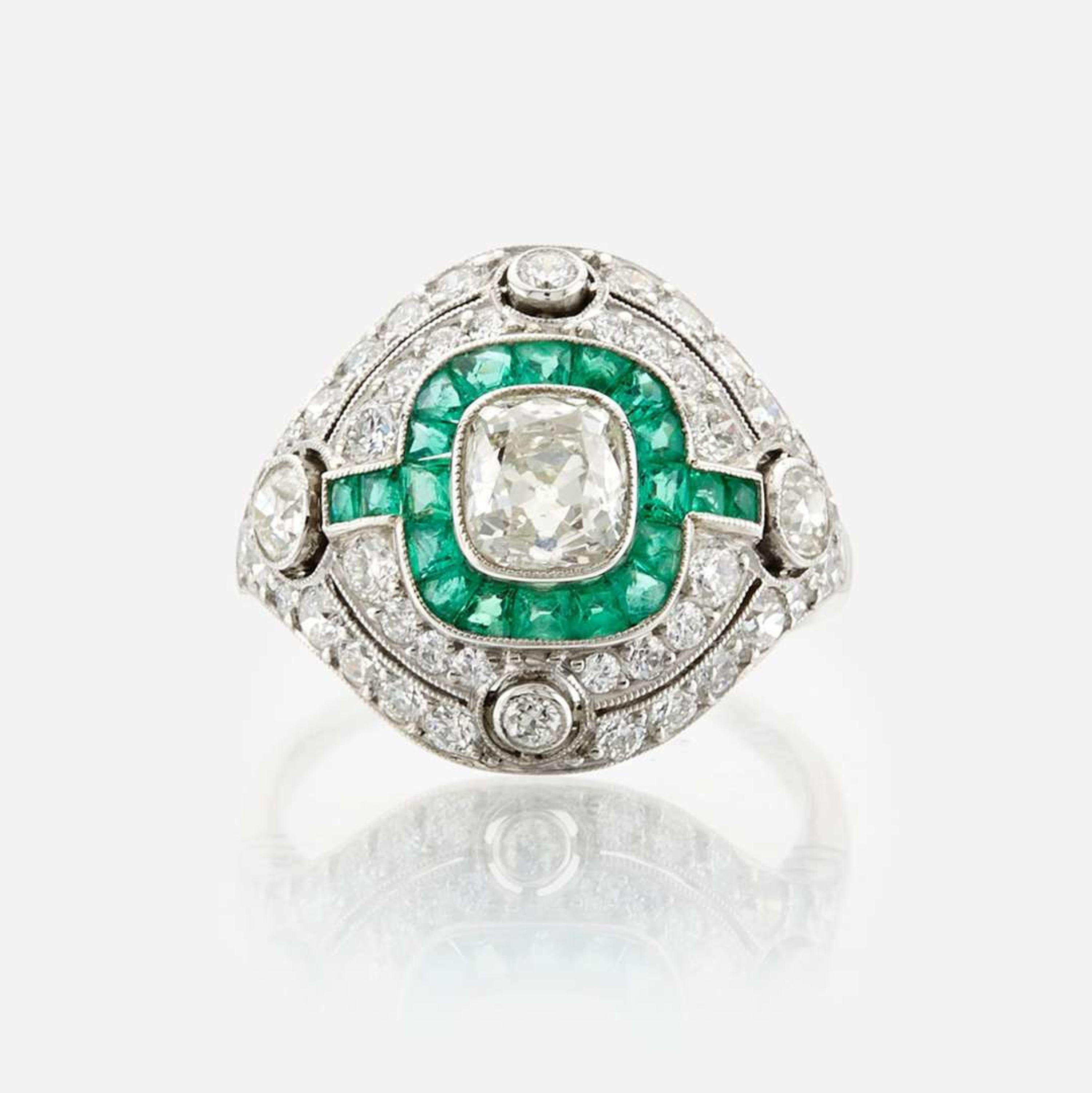 A diamond, emerald, and platinum ring