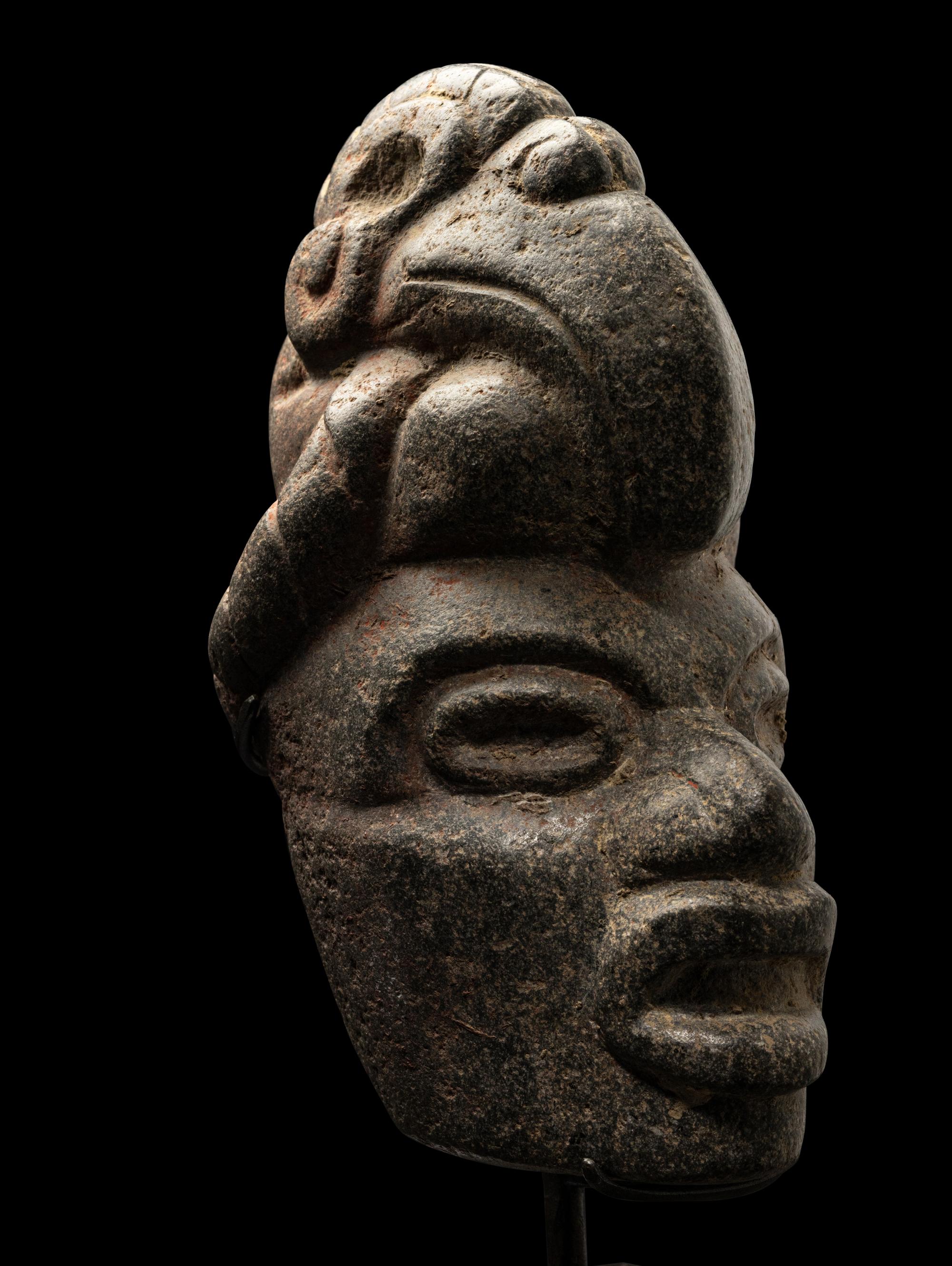 A Maya Stone Hacha of a Warrior Wearing a Helmet in the Form of a Macaw