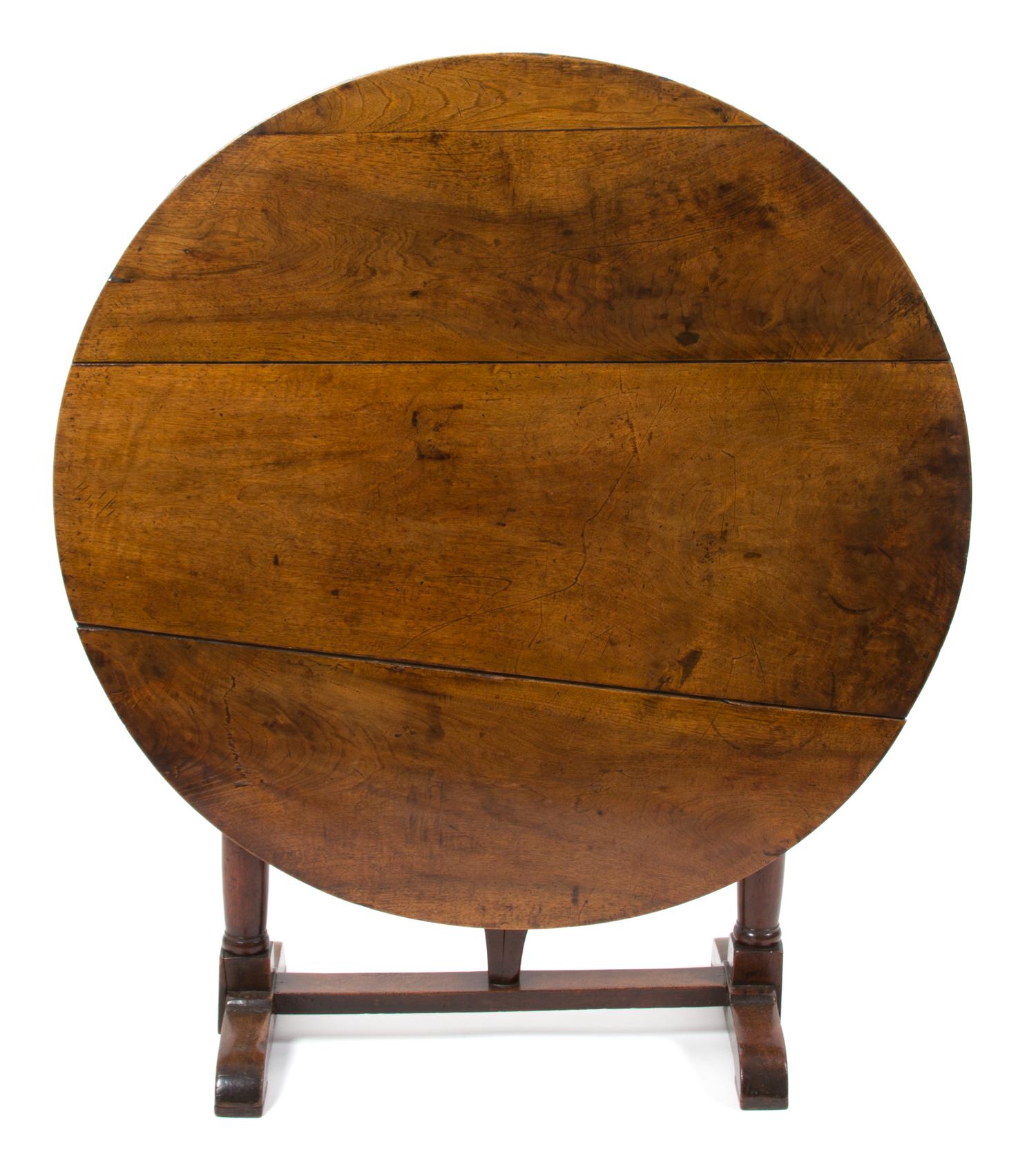 A Continental Provincial Style Walnut Tilt-Top Table Height 28 1/2 x diameter 42 inches. — 19TH CENTURY