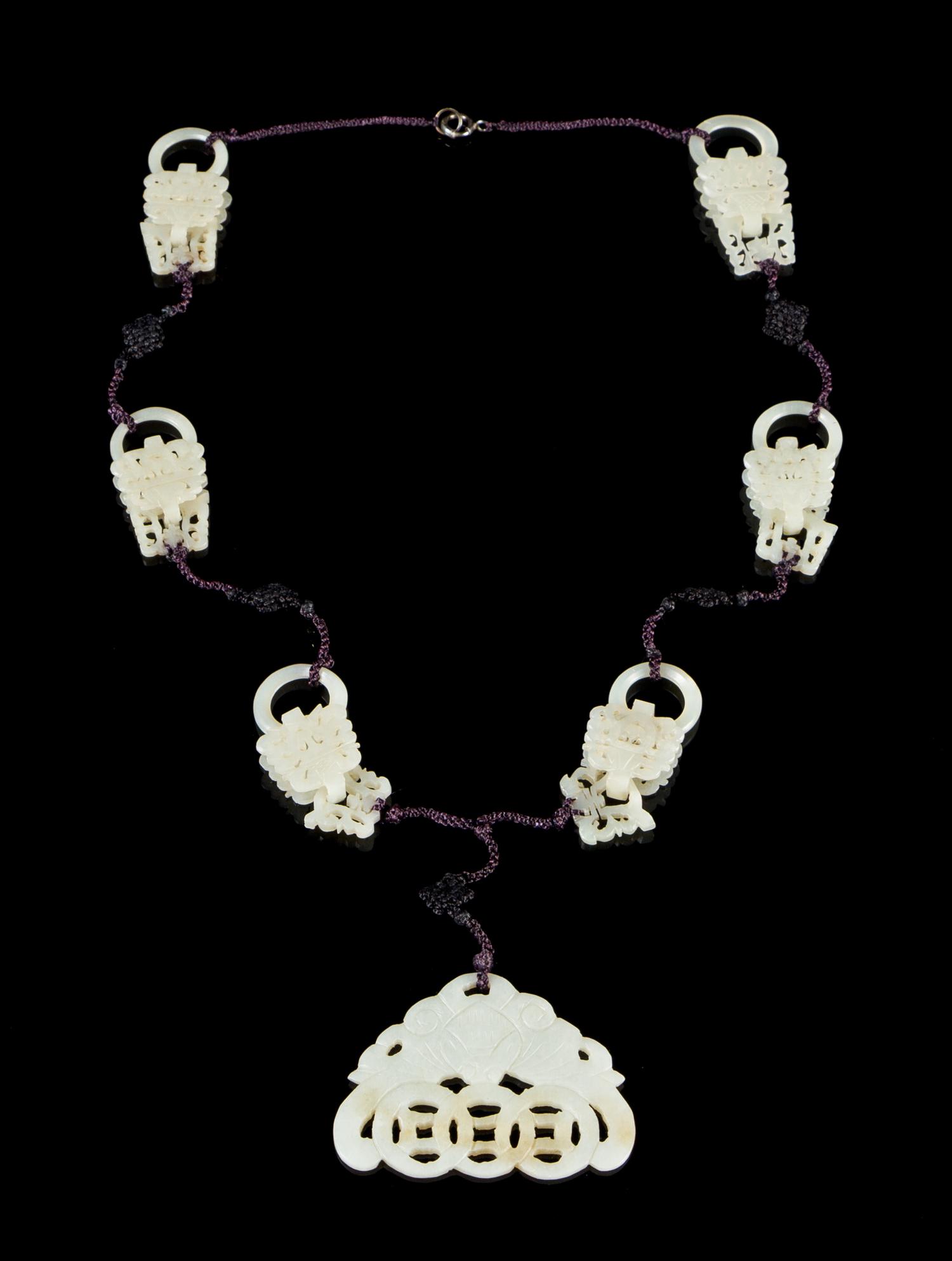 A Carved Jade Necklace Overall length 16 inches.