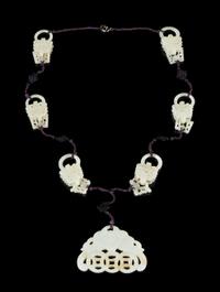 A Carved Jade Necklace Overall length 16 inches.