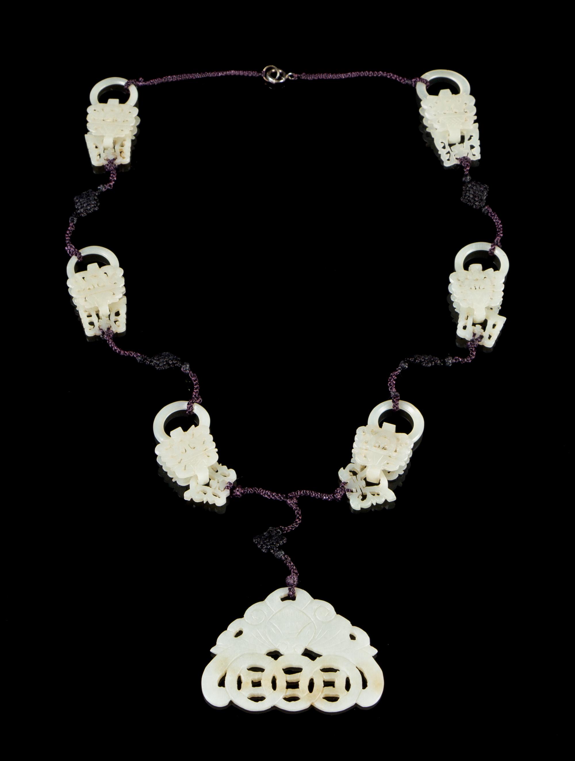 A Carved Jade Necklace Overall length 16 inches.