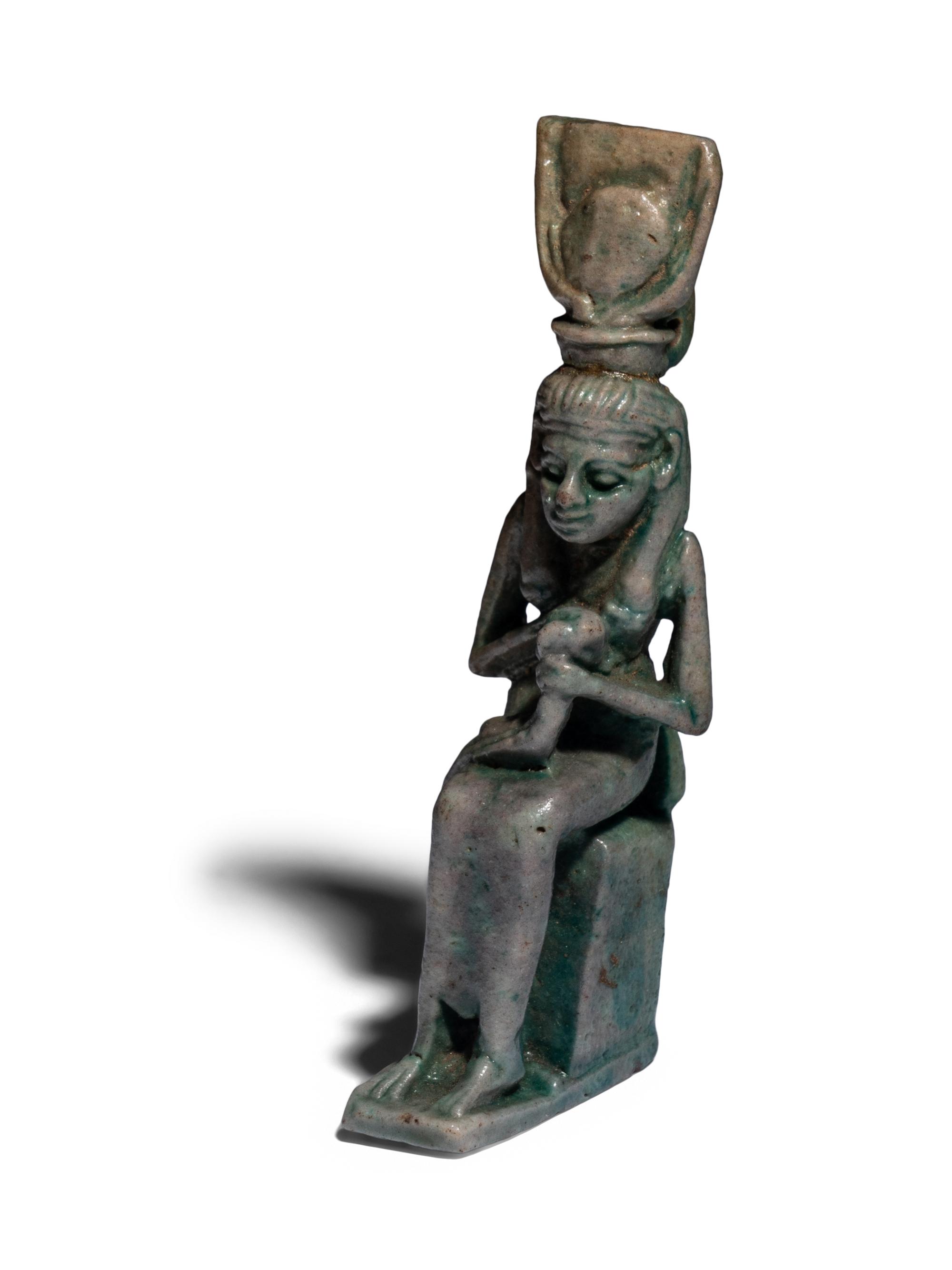 An Egyptian Faience Isis Nursing Horus Amulet