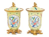 A Pair of French Gilt Bronze Mounted Porcelain Covered Jars Height 8 inches.