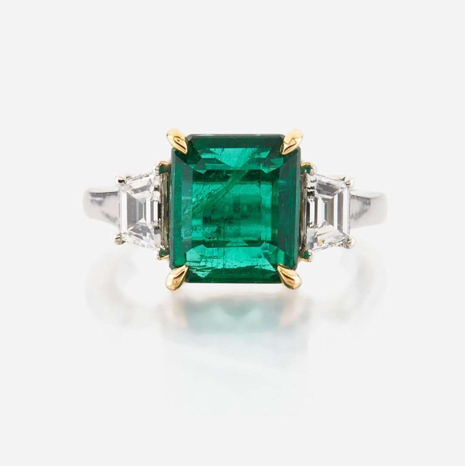 An emerald, diamond, and platinum ring