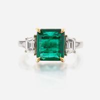 An emerald, diamond, and platinum ring