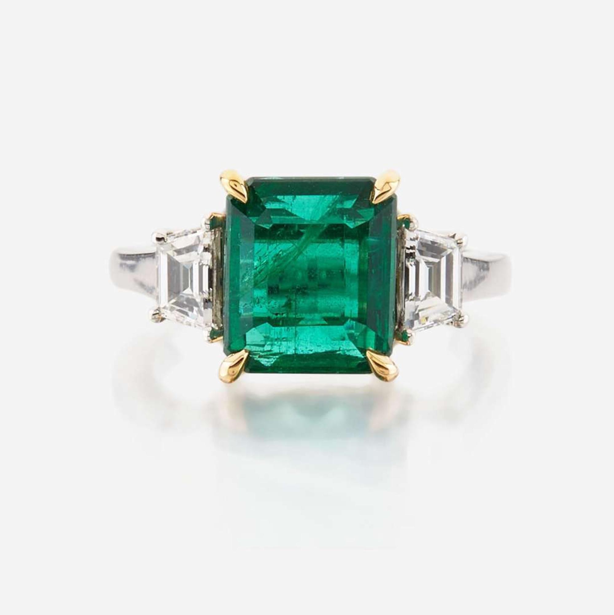 An emerald, diamond, and platinum ring