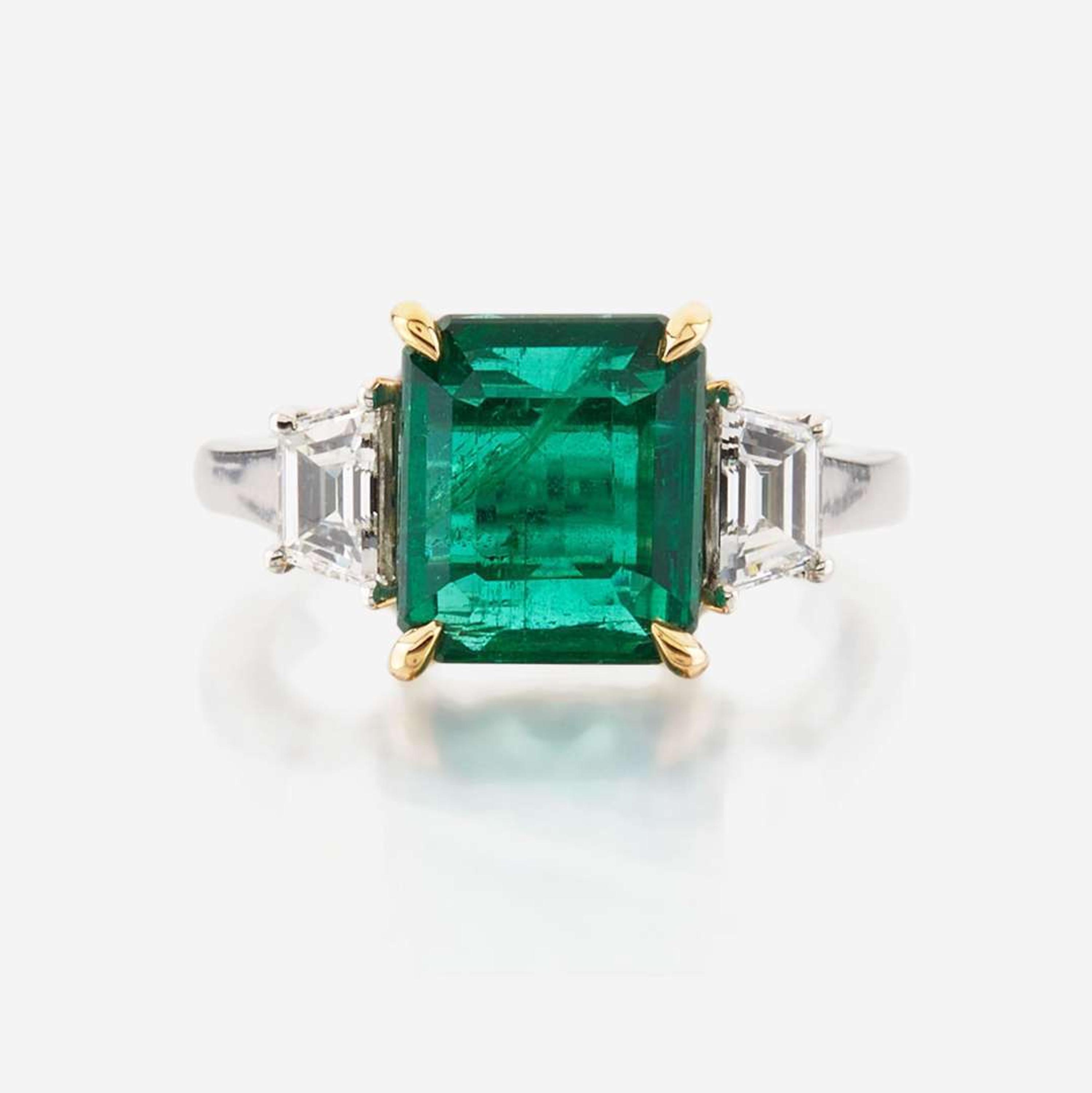 An emerald, diamond, and platinum ring