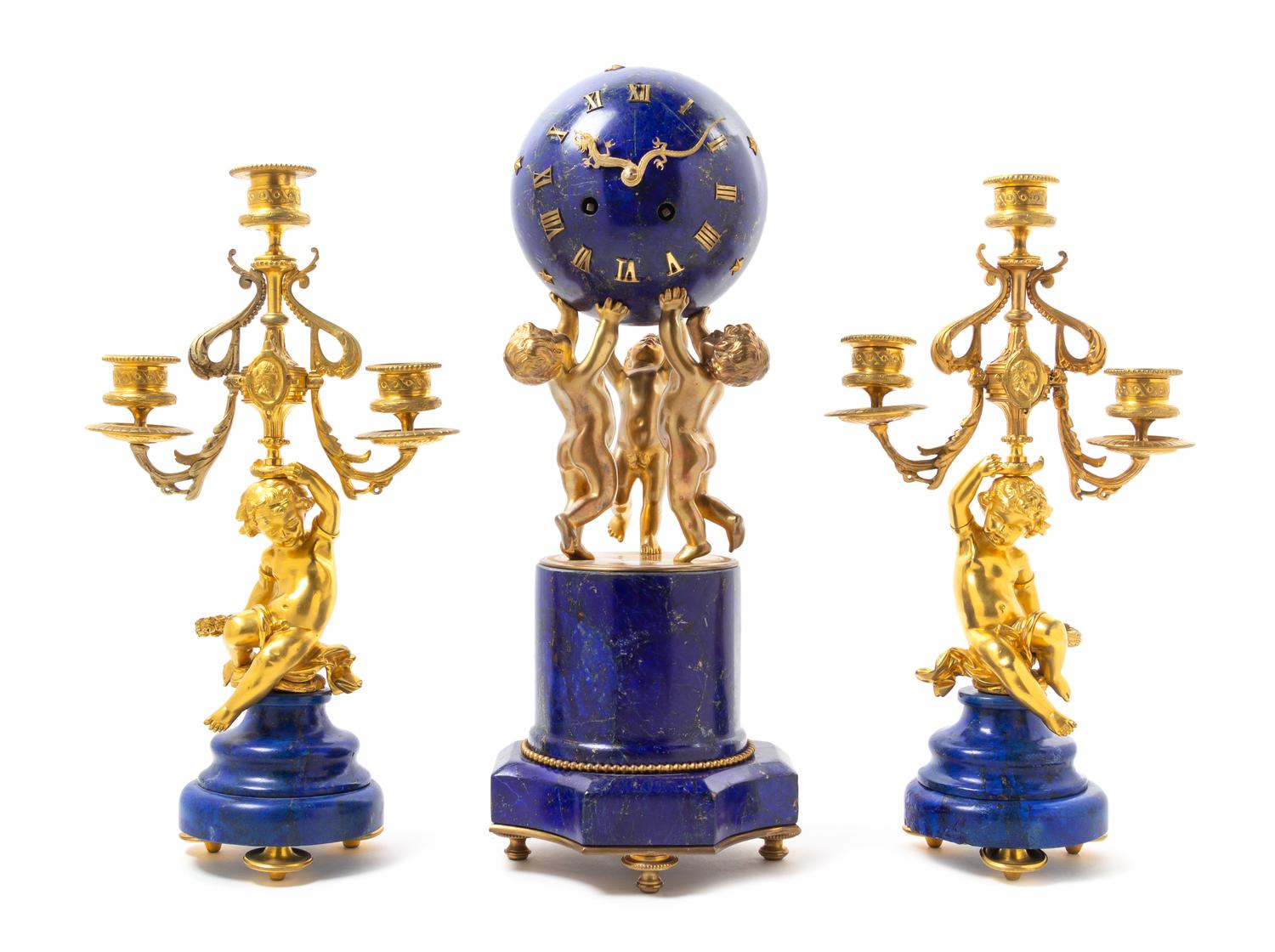 A French Lapis Lazuli and Gilt Bronze Clock Garniture Height of mantel clock 16 1/4 inches. — 19TH CENTURY