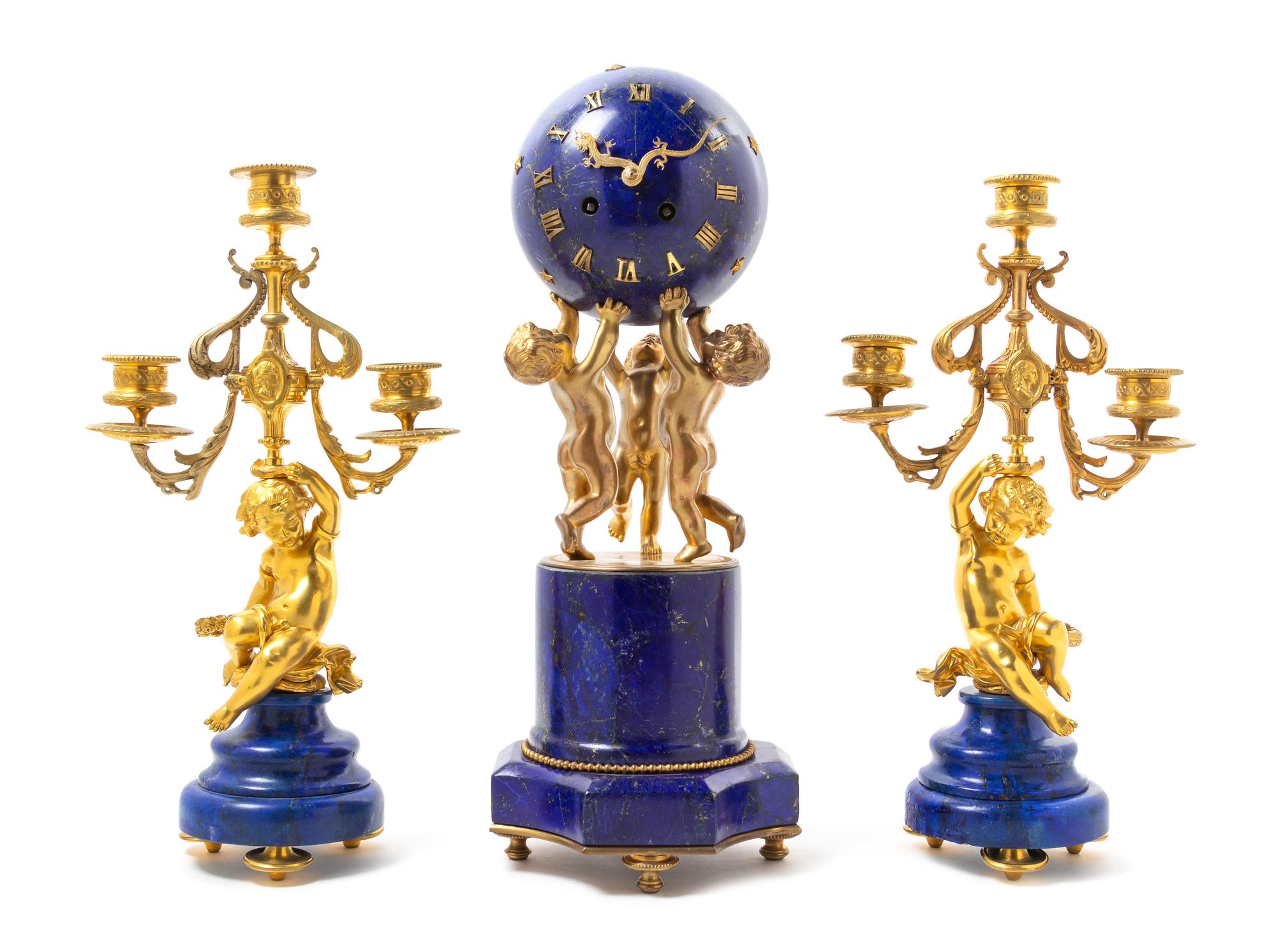A French Lapis Lazuli and Gilt Bronze Clock Garniture Height of mantel clock 16 1/4 inches. — 19TH CENTURY