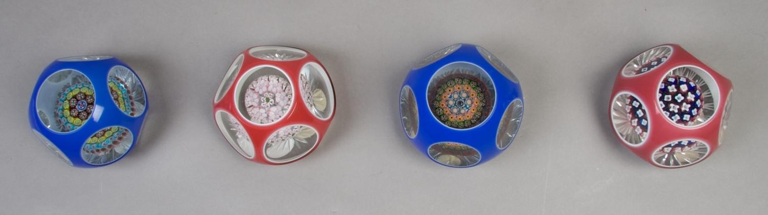 A Collection of Four Cased Glass Paperweights, Diameter 3 1/2 inches.