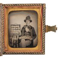 [EARLY PHOTOGRAPHY]. Sixth plate ambrotype featuring a jewelry salesman displaying his wares.