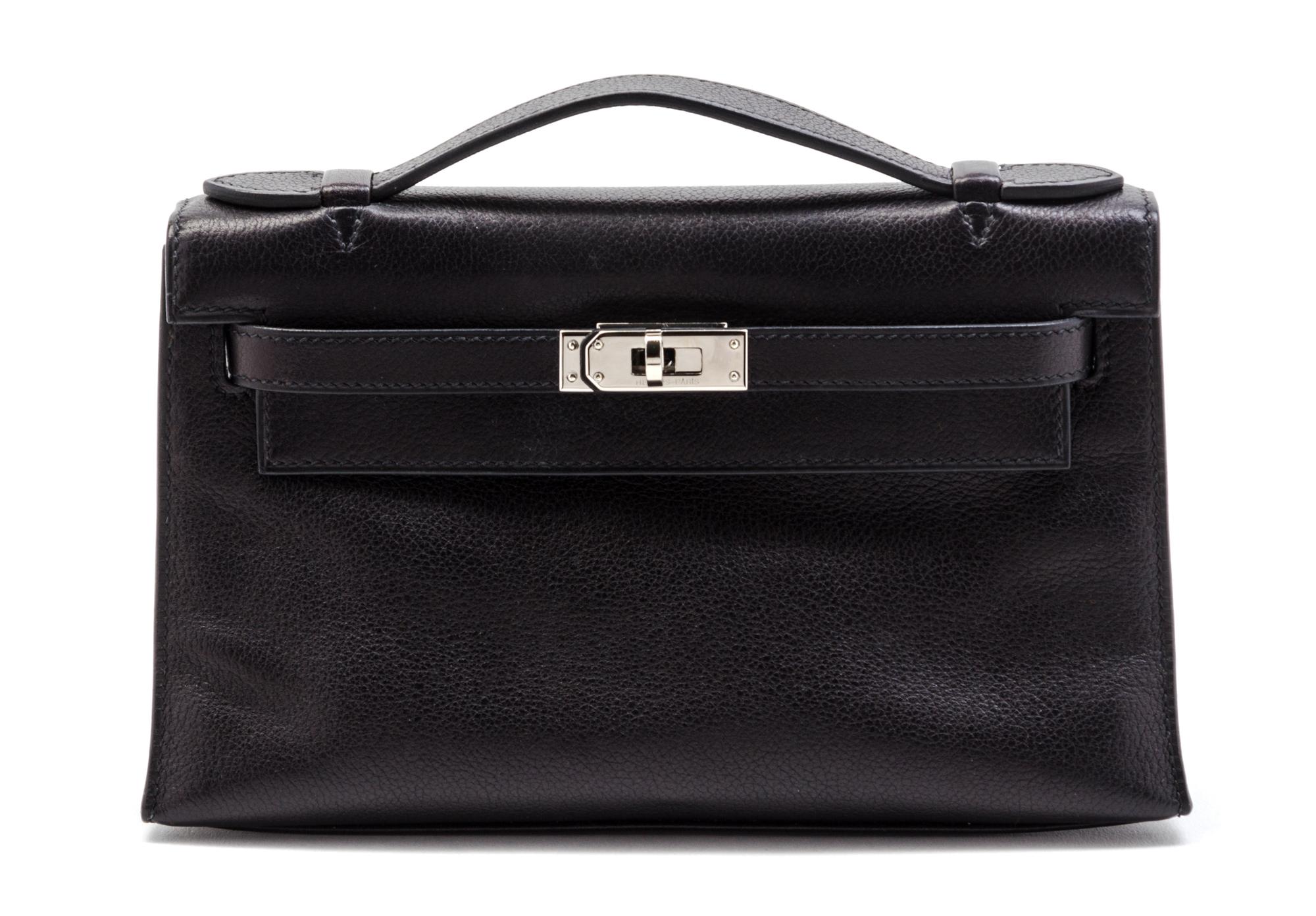An Hermes Black Leather Kelly Clutch Pochette, 8 1/2 x 5 x 2 1/2 inches.