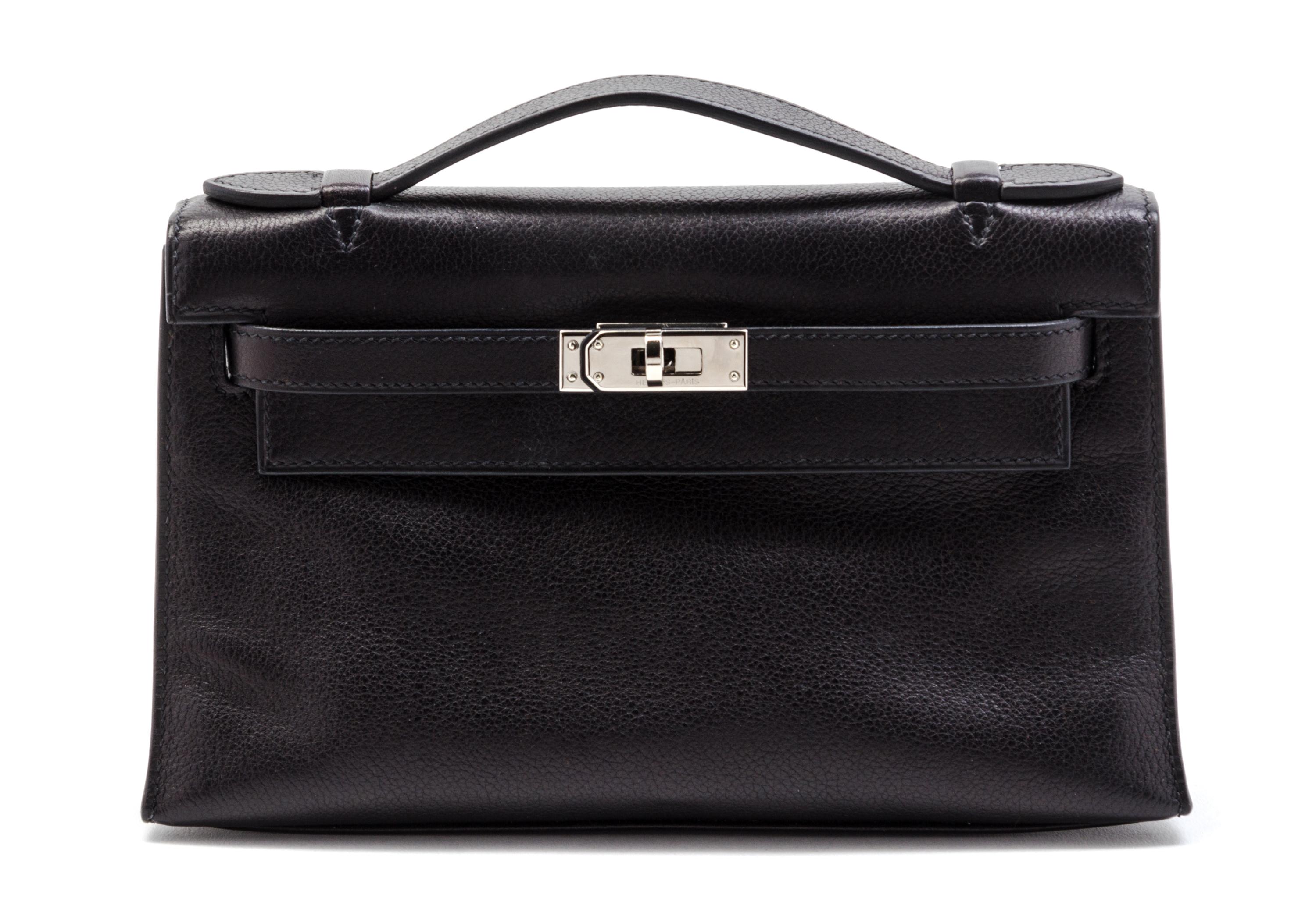 An Hermes Black Leather Kelly Clutch Pochette, 8 1/2 x 5 x 2 1/2 inches.