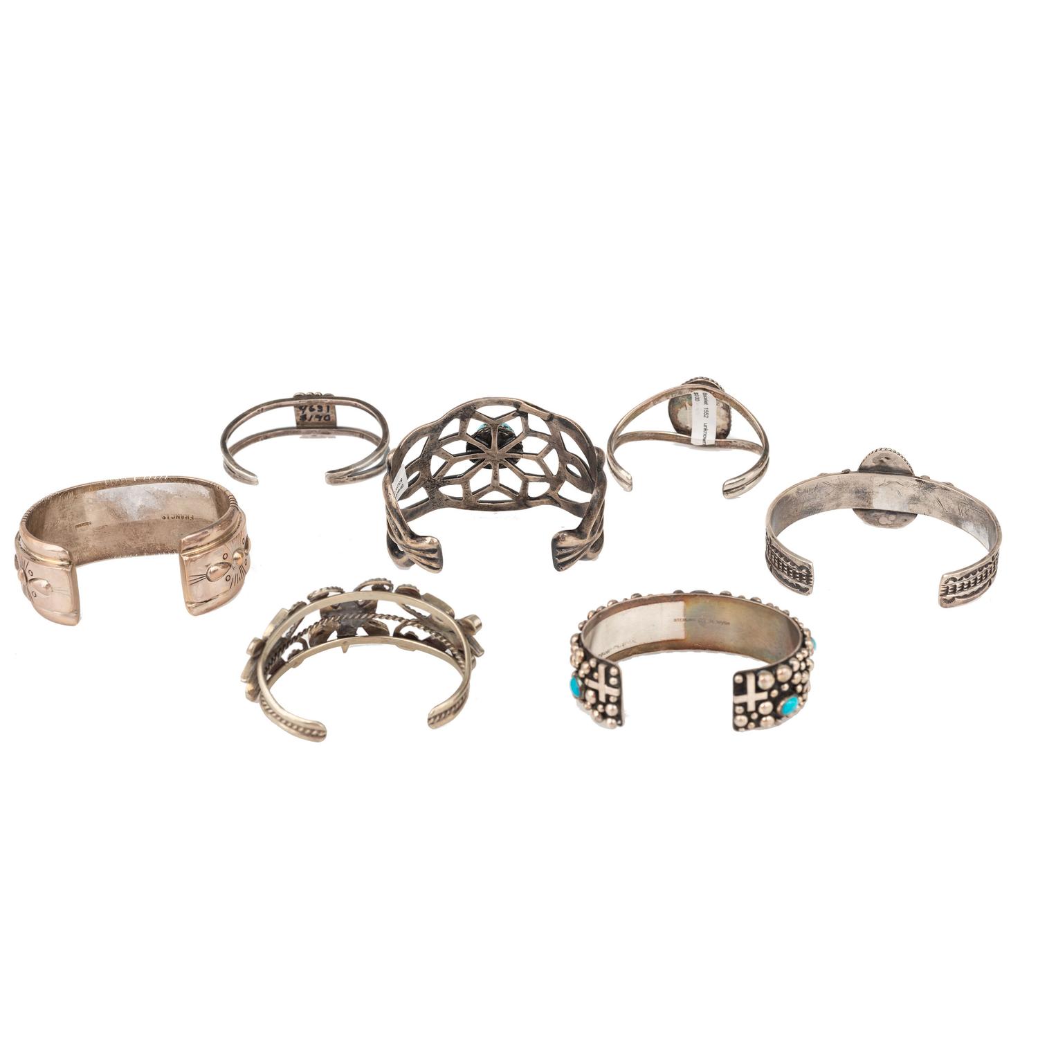 Selection of Navajo, Hopi, and Zuni Silver Bracelets and Earrings, with Inlay