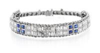 A Platinum, White Gold, Diamond and Synthetic Sapphire Bracelet, 21.30 dwts.