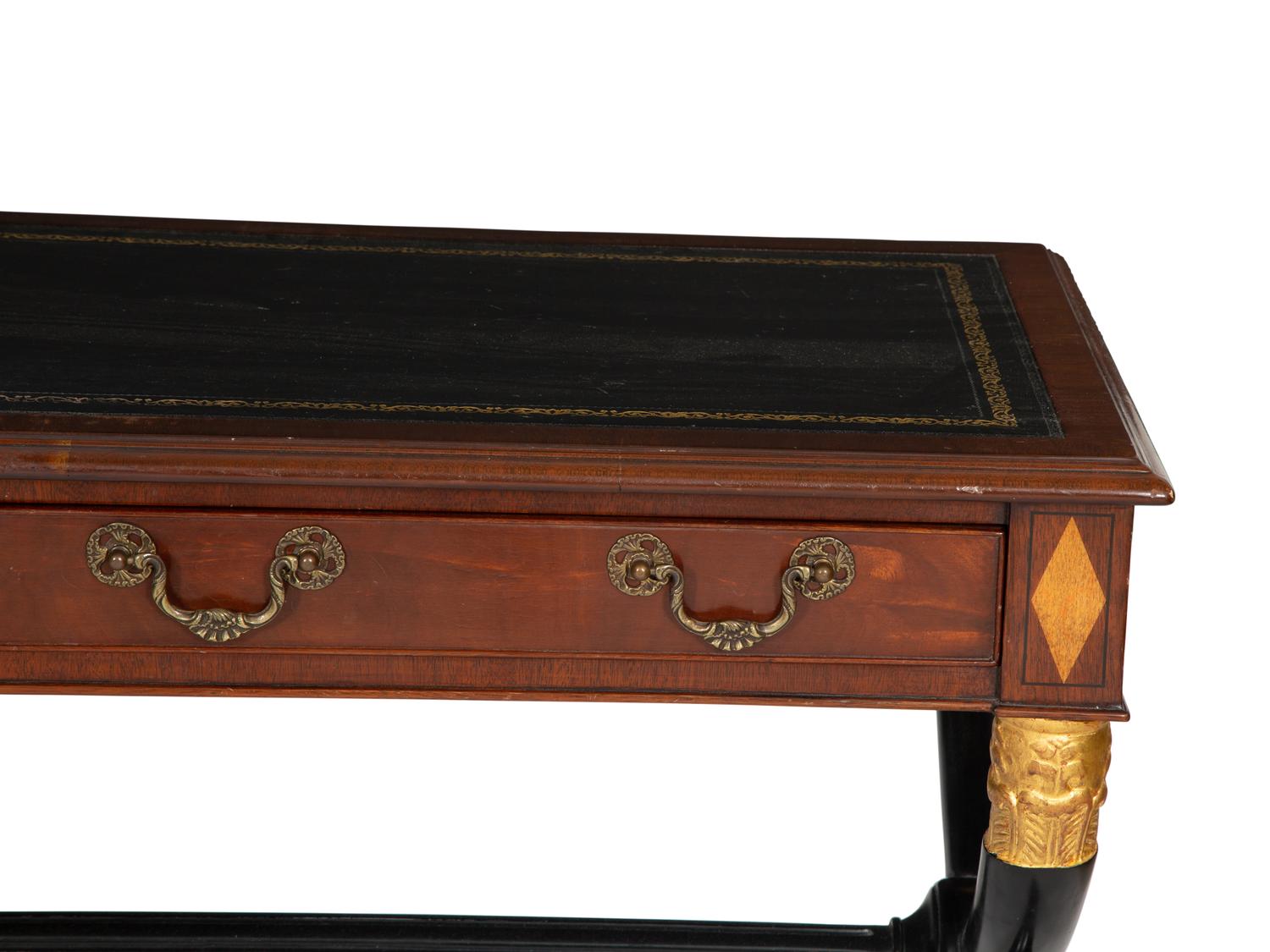 A Regency Style Parcel Gilt and Ebonized Mahogany Leather Top Console Table