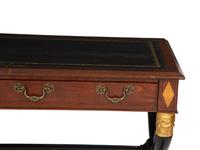 A Regency Style Parcel Gilt and Ebonized Mahogany Leather Top Console Table
