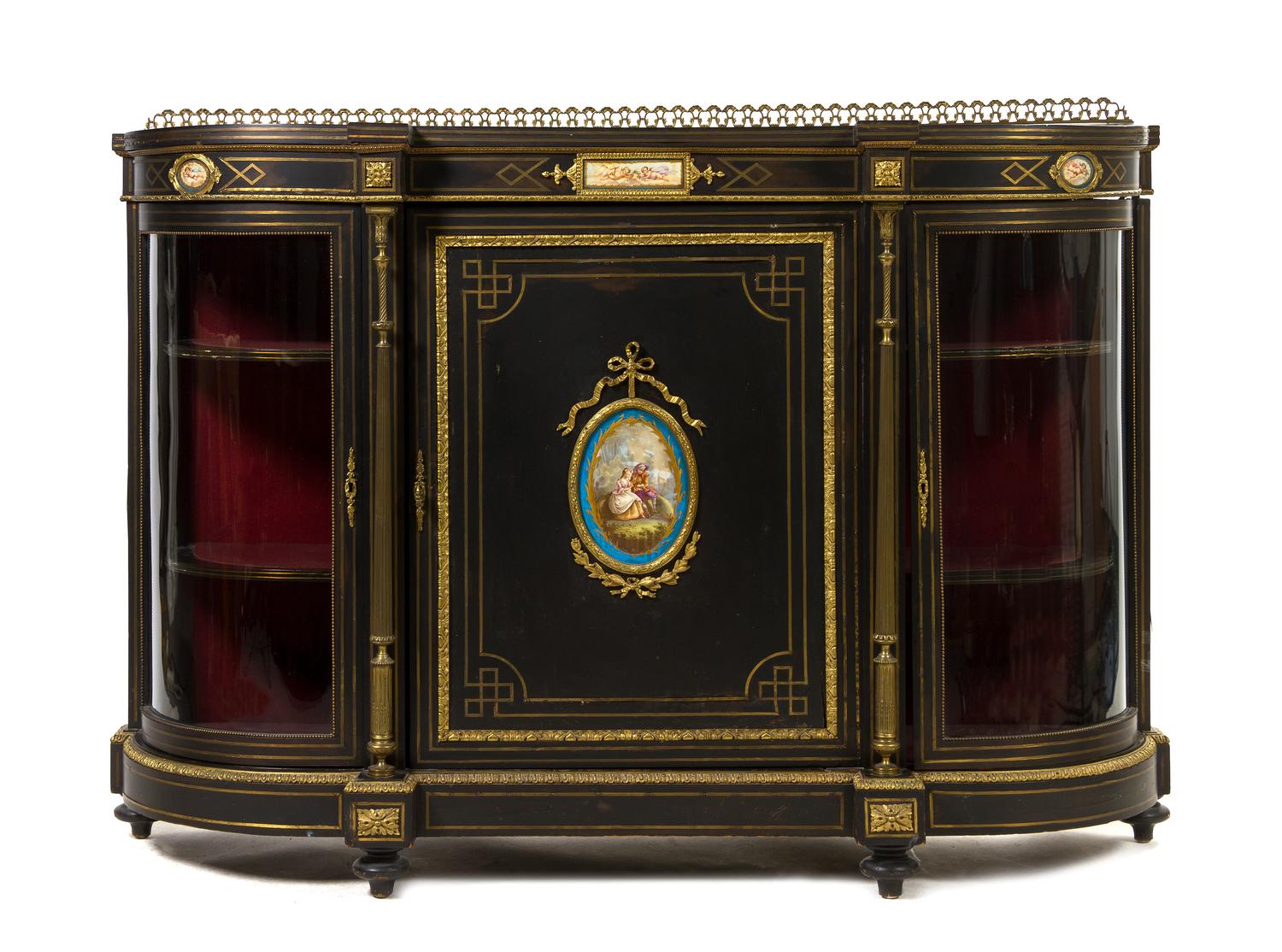 A Napoleon III Ebonized, Gilt Metal Mounted and Porcelain Inset Console Cabinet, Height 43 3/4 x width 62 1/4 x depth 17 inches.