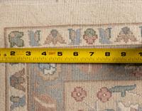 An Ivory and Pastel Rug
