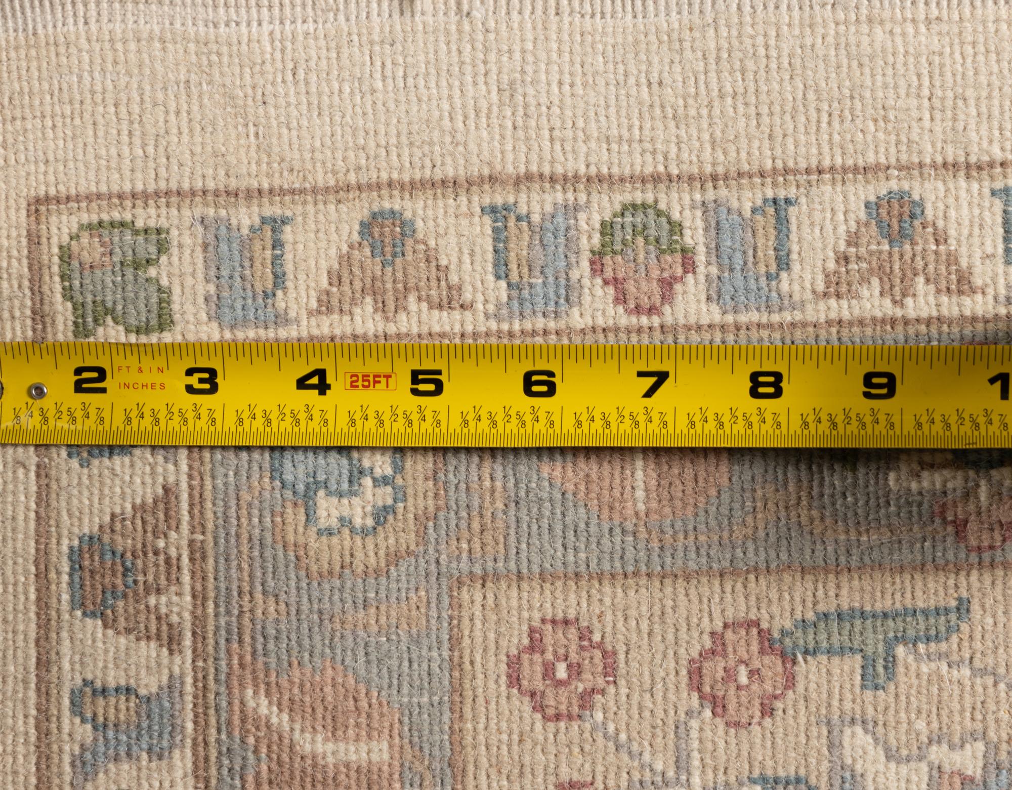 An Ivory and Pastel Rug