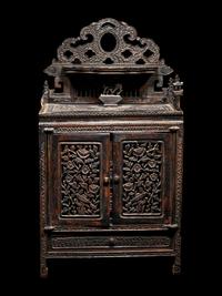 A Chinese Export Carved Hardwood Cabinet