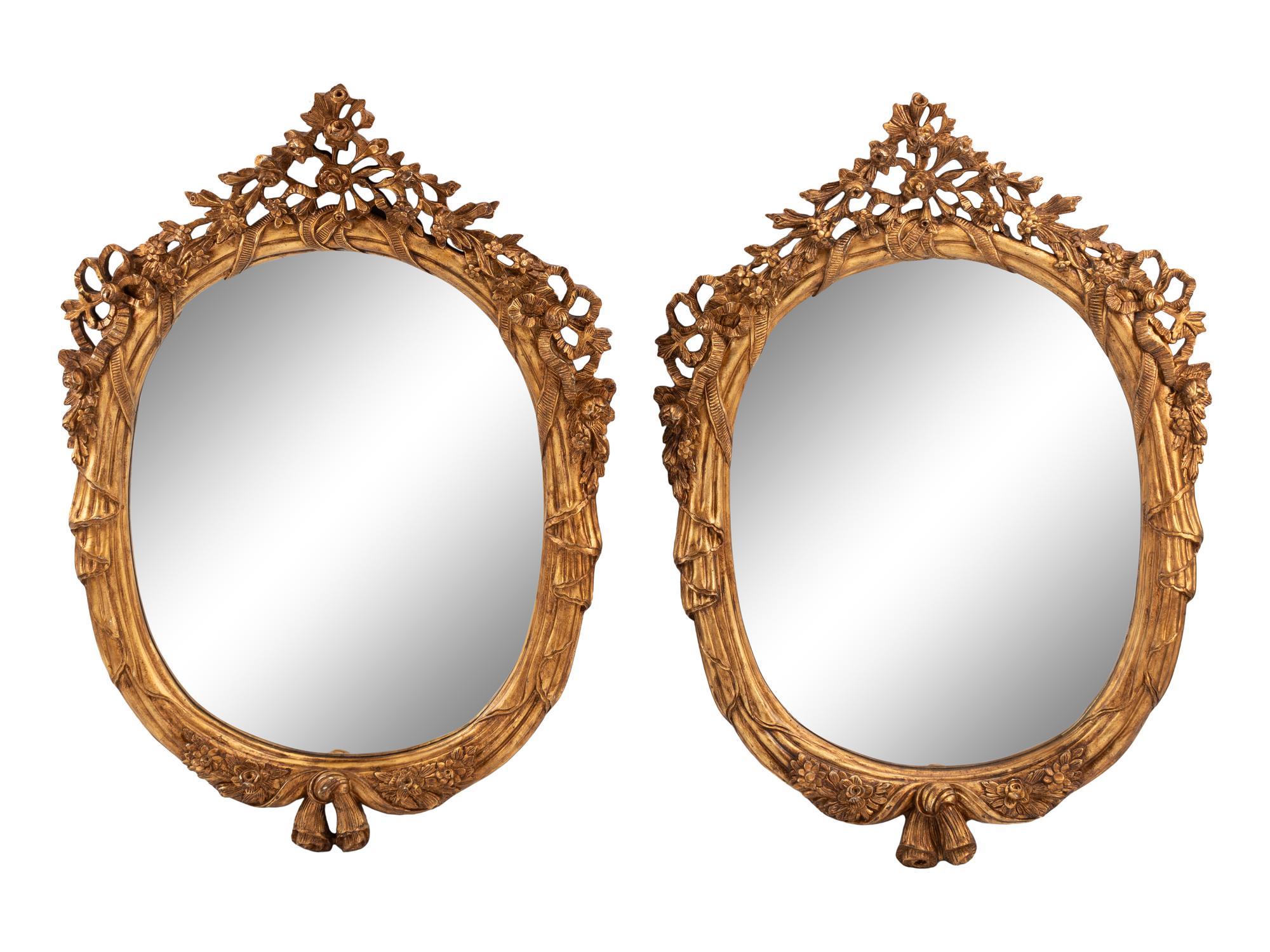 A Pair of Italian Carved Giltwood Oval Mirrors