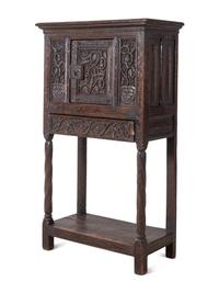 A Gothic Revival Carved Oak Cabinet on Stand