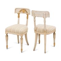 A Suite of Four Gustavian Style Painted and Parcel Gilt Chairs