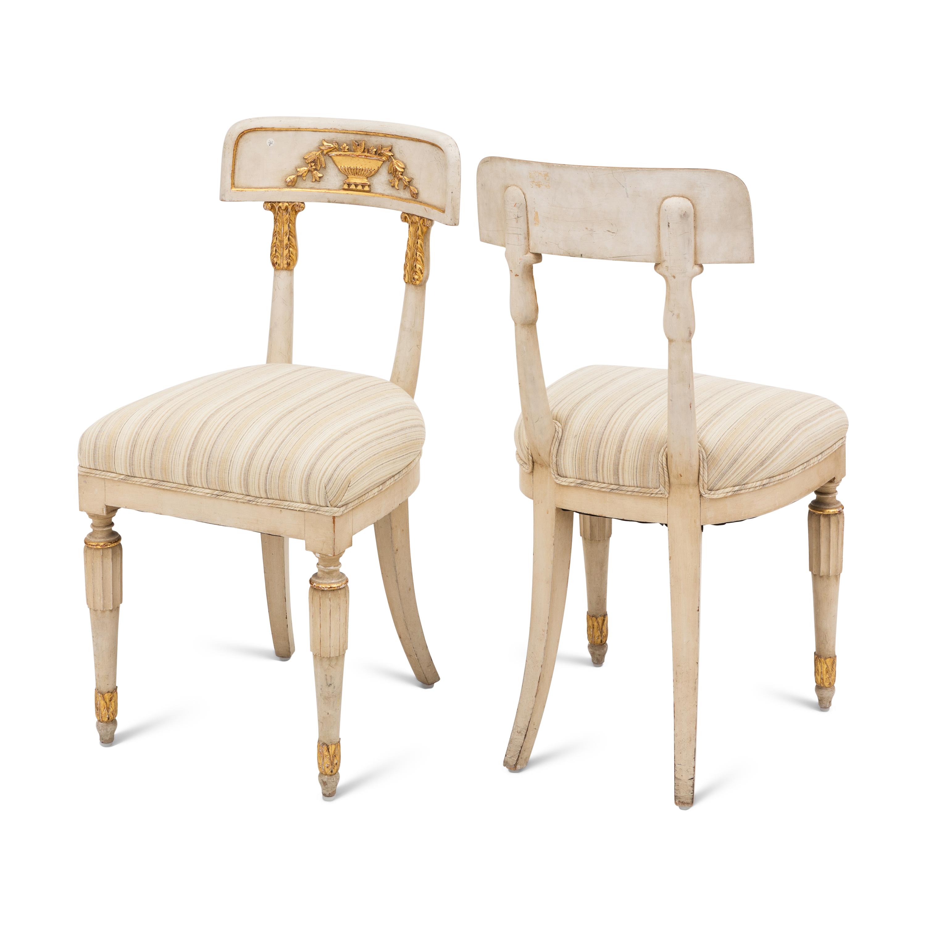 A Suite of Four Gustavian Style Painted and Parcel Gilt Chairs