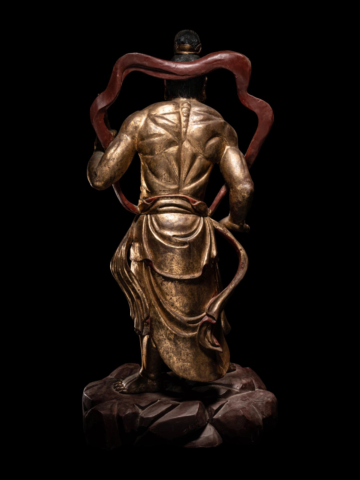 A Pair of Chinese Gilt and Red Lacquered Wood Figures of Wrathful Guardians