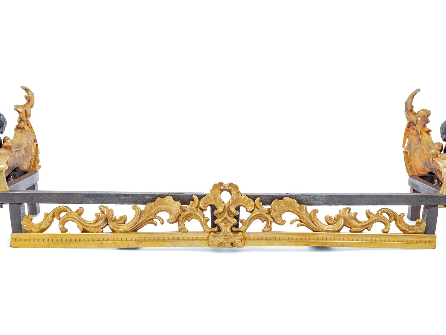 A Pair of French Gilt and Patinated Bronze Figural Chenets and Fender