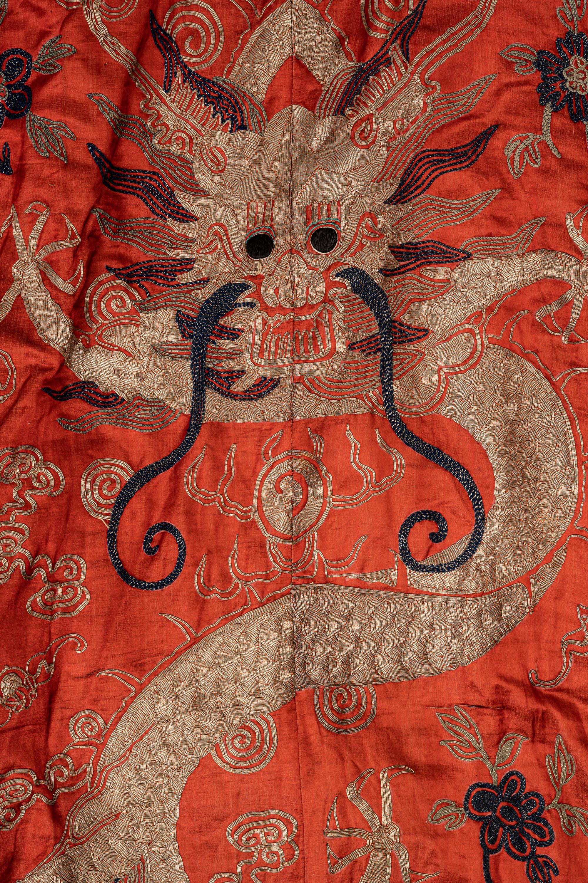 A Chinese Orange Ground Embroidered Silk Theatrical Dragon Robe