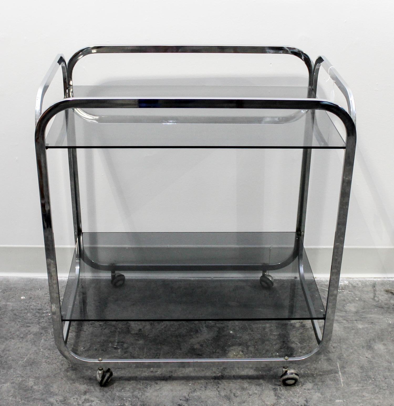 An Aluminum and Smoked Glass Bar Cart Height 27 3/4 x width 25 x depth 17 inches. — CIRCA 1970s