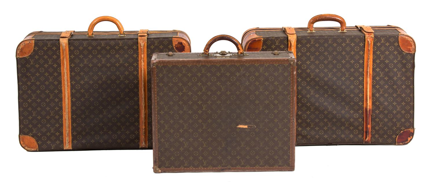 A Group of Three Louis Vuitton Suitcases Largest height 22 x width 30 x depth 10 inches. Hard case 16 x width 24 x depth 6 3/4 inches. — 20TH CENTURY